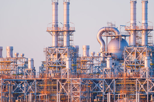 Industrial pipes and equipment at an oil refinery plant. Heavy manufacturing infrastructure for petroleum production.