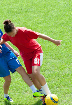 Female Soccer Players Competing for Ball During Match