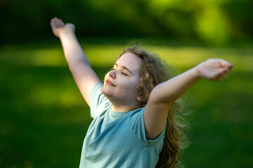 Naklejka premium Carefree child enjoys summer meadow. Carefree childhood feels peaceful outdoors. Happy carefree kid opens arms. Natural carefree joy fills field.