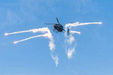 Black modern military transport helicopter shrouded in smoke over Budapest © ZenitX