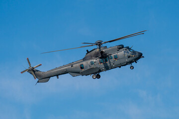 Fototapeta premium Black modern military transport helicopter flying over Budapest, Hungary