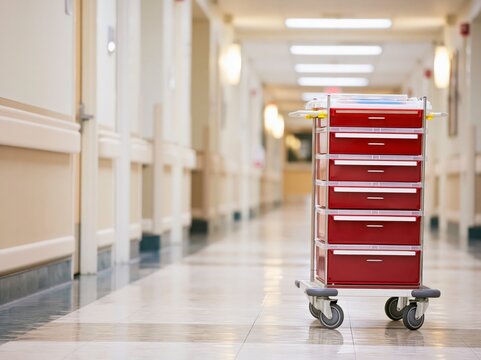 Medical supply cart in quiet hospital hallway highlights healthcare worker shortage