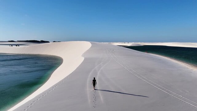 Moving Past a Lone Walker on a Lagoon-Bordered Sand Spit