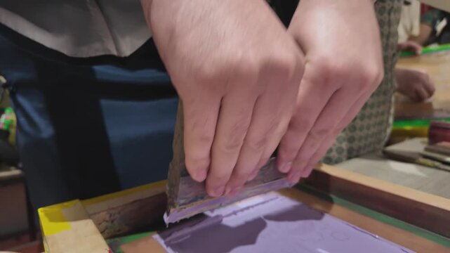 Screen printing process with ink and squeegee