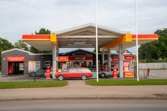 VALMIERA, LATVIA &ndash; AUGUST 14, 2026: Classic red Mercedes-Benz station wagon parked at a Circle K gas station
