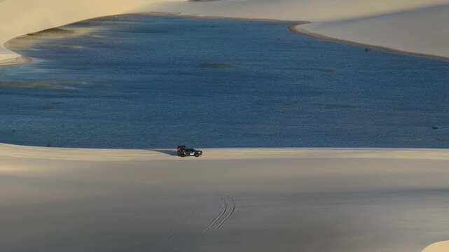 Four-Wheel-Drive Tour Vehicle Crossing Dunes Between Len&ccedil;&oacute;is Maranhenses Lagoons