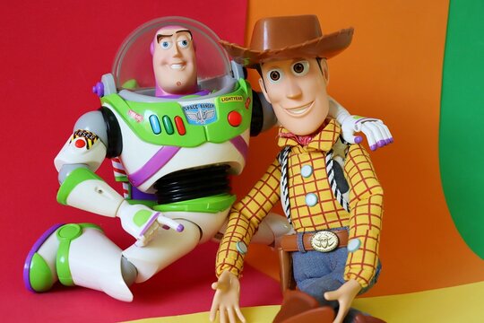 Salvador, Brazil - August 15, 2026: Woody and Buzz Lightyear action figures on a colorful background. Disney Pixar Toy Story characters.