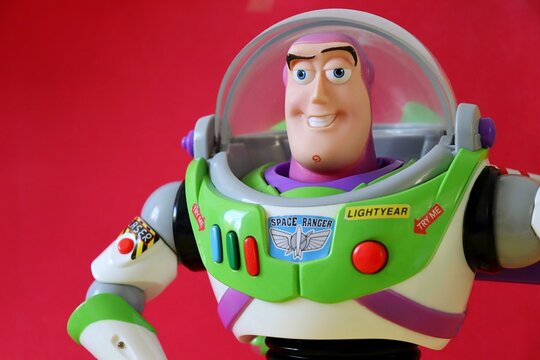 Salvador, Brazil - August 15, 2026: Buzz Lightyear action figure on a red background. Disney Pixar Toy Story character.