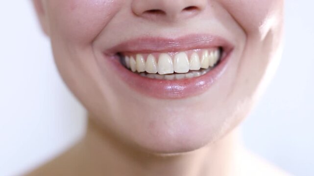 Close-up young happy woman smiling and laughing with beautiful white teeth