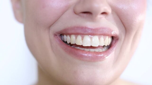 Close-up young happy woman smiling and laughing with beautiful white teeth