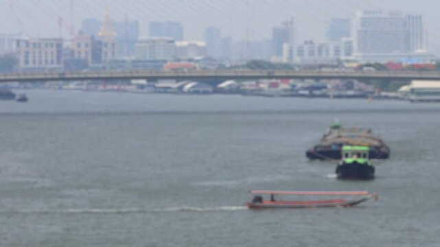 Bokeh view of ferry boats sailing on the Chao Phraya River, Bangkok, Thailand. Blurred background footage.