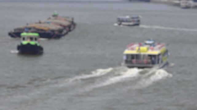 Bokeh view of ferry boats sailing on the Chao Phraya River, Bangkok, Thailand. Blurred background footage.