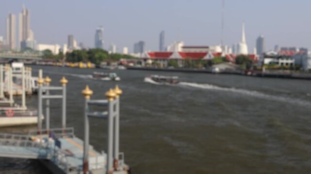 Bokeh view of ferry boats sailing on the Chao Phraya River, Bangkok, Thailand. Blurred background footage.