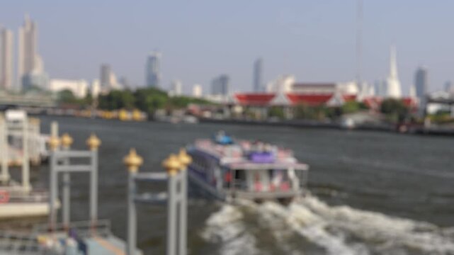 Bokeh view of ferry boats sailing on the Chao Phraya River, Bangkok, Thailand. Blurred background footage.