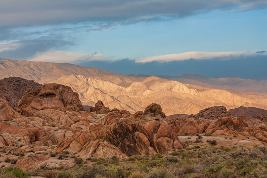 Beautiful wide scenic panorama of rocky desert mountains at golden sunset in Alabama Hills