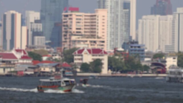 Bokeh view of ferry boats sailing on the Chao Phraya River, Bangkok, Thailand. Blurred background footage.