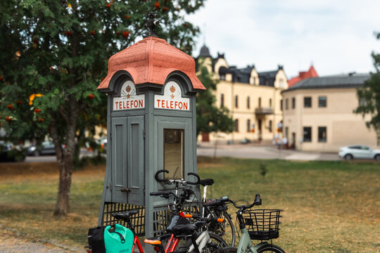 Mariefred Sweden historic telephone booth with bicycles parked