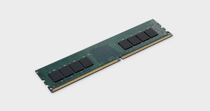 Green computer ram module dropping and bouncing on white background with camera panning right