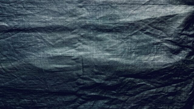 crumpled graphite linen fabric texture rippling under soft light as moody backdrop for banner and web design