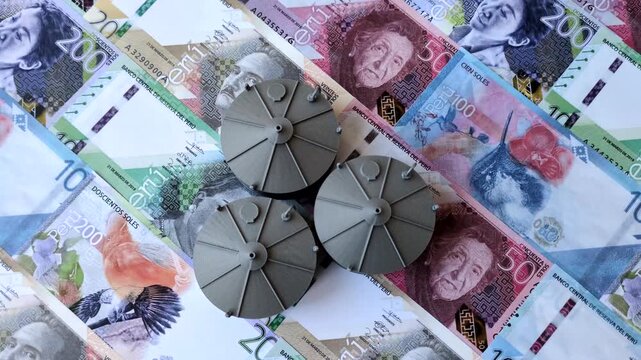 Liquefied gas storage tanks set against the Peruvian money as a background for your design