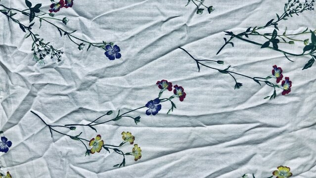 wrinkled linen floral fabric texture with wildflower sprigs for sustainable branding packaging and web design backdrop