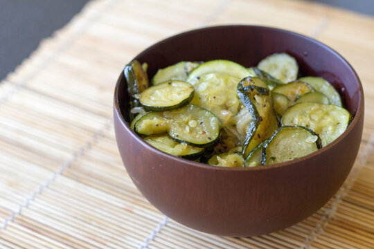 Pan Fried Zucchini Slices With Mint Served In Ceramic Bowl