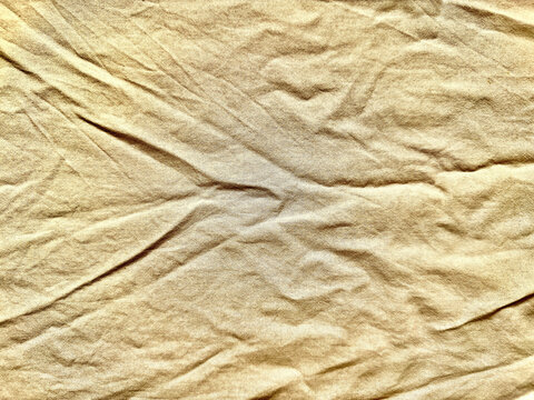wrinkled beige linen fabric texture background for sustainable branding web design and authentic wellness advertising