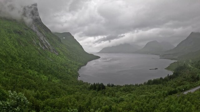 High angle static ultra wide view of scenic Norwegian fjord and green mountains in Bergsbotn Senja Norway