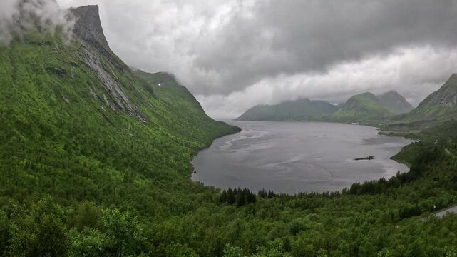 High angle static ultra wide view of scenic Norwegian fjord and green mountains in Bergsbotn Senja Norway