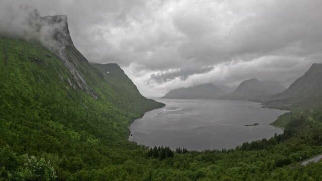 High angle static ultra wide view of scenic Norwegian fjord and green mountains in Bergsbotn Senja Norway