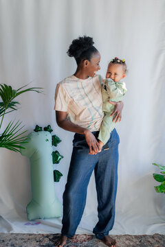 Mother and child posing together near one year balloon 