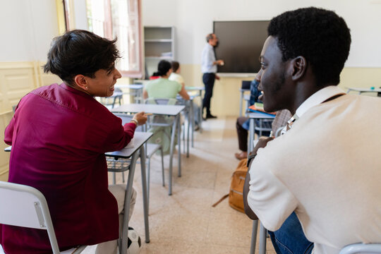 Diverse students actively engaging in classroom discussion at school
