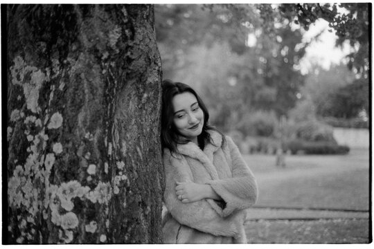 Thoughtful woman at park tree
