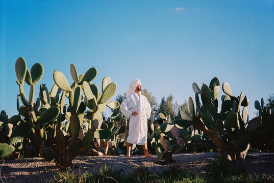 Film Picture of Man With White Robe Standing Among Cactus