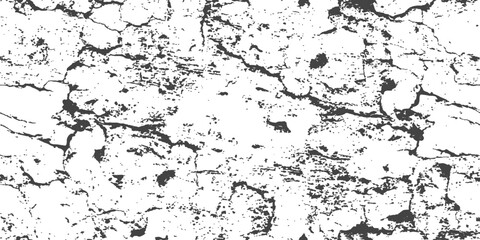 Fototapeta premium Cracked dry earth texture with deep fissures and rough surface during harsh sunlight with a gritty feel