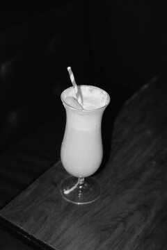 Frothy cocktail with striped straw
