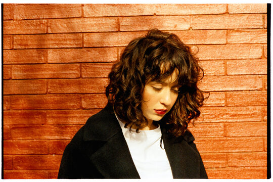 Young woman looking downward thoughtfully
