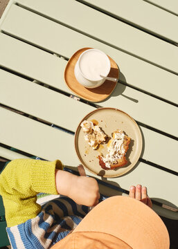 Toddler Enjoying Dessert and Milk on a Sunny Day at a Cafe