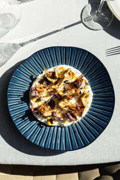Gourmet cheese cream topped with crispy fried artichokes and microgree