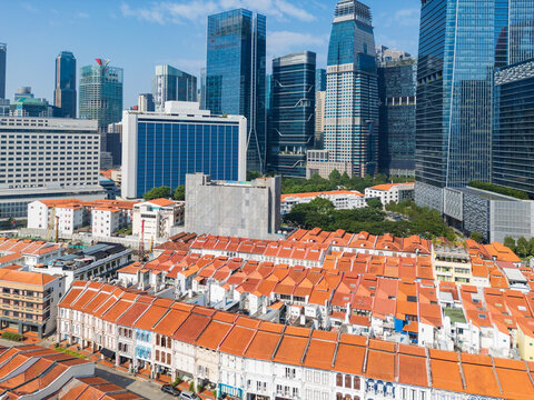Colorful row houses in front of high rise city skyscapers