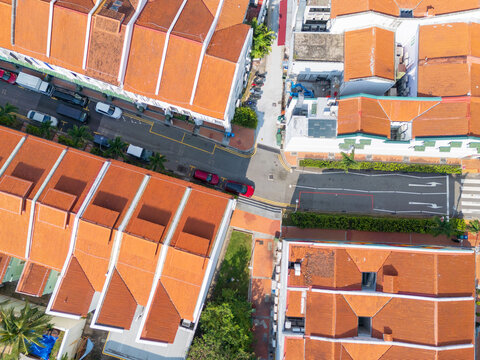 Traffic on roads between row hoses with terracotta tiled roofs