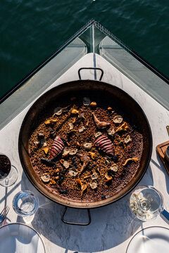 Overhead view of a traditional Spanish seafood paella by the sea