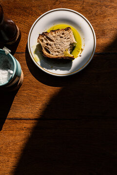 Artisanal sourdough bread with olive oil on a rustic wooden table