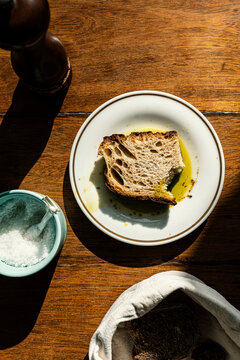 Artisanal sourdough bread with olive oil on a rustic wooden table