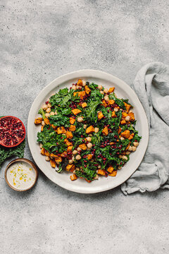 Top-down view of a nutritious winter kale salad with dressing