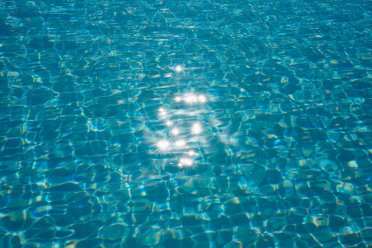 Sunlight Sparkling on Clear Swimming Pool Water