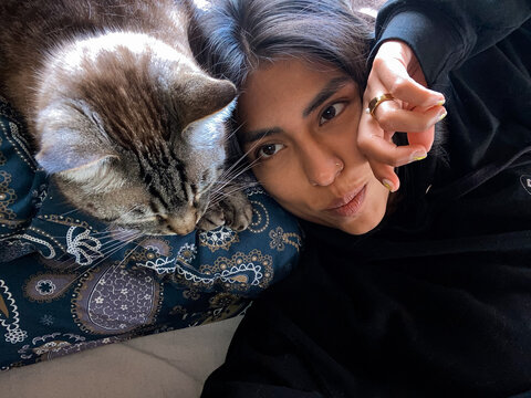 Person Lying with Tabby Cat