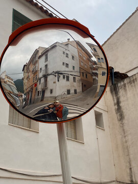 Couple Reflected in Street Mirror