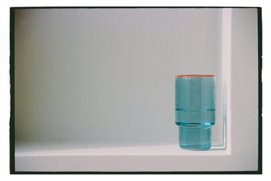 Blue  glass on a white shelf