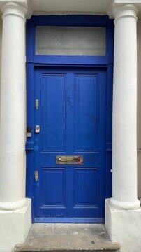 Traditional blue front door number 280 on Portobello Road, London, England, featuring the distinctive architecture and character of the famous Notting Hill area in London, United Kingdom.